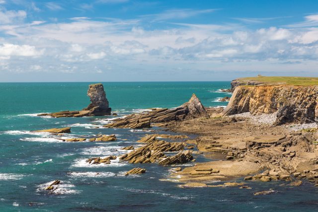 Limestone sea stack known as Pen y Holt stack on the Castlemartin Firing Range, 