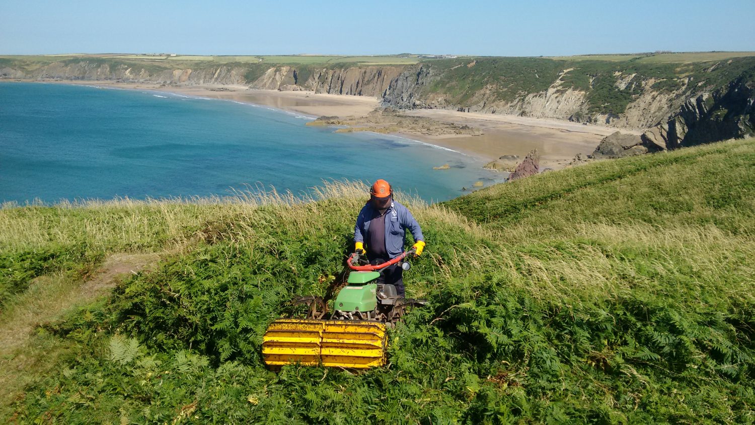 National Park Authority Warden using machine on Coast Path near Marloes Sands