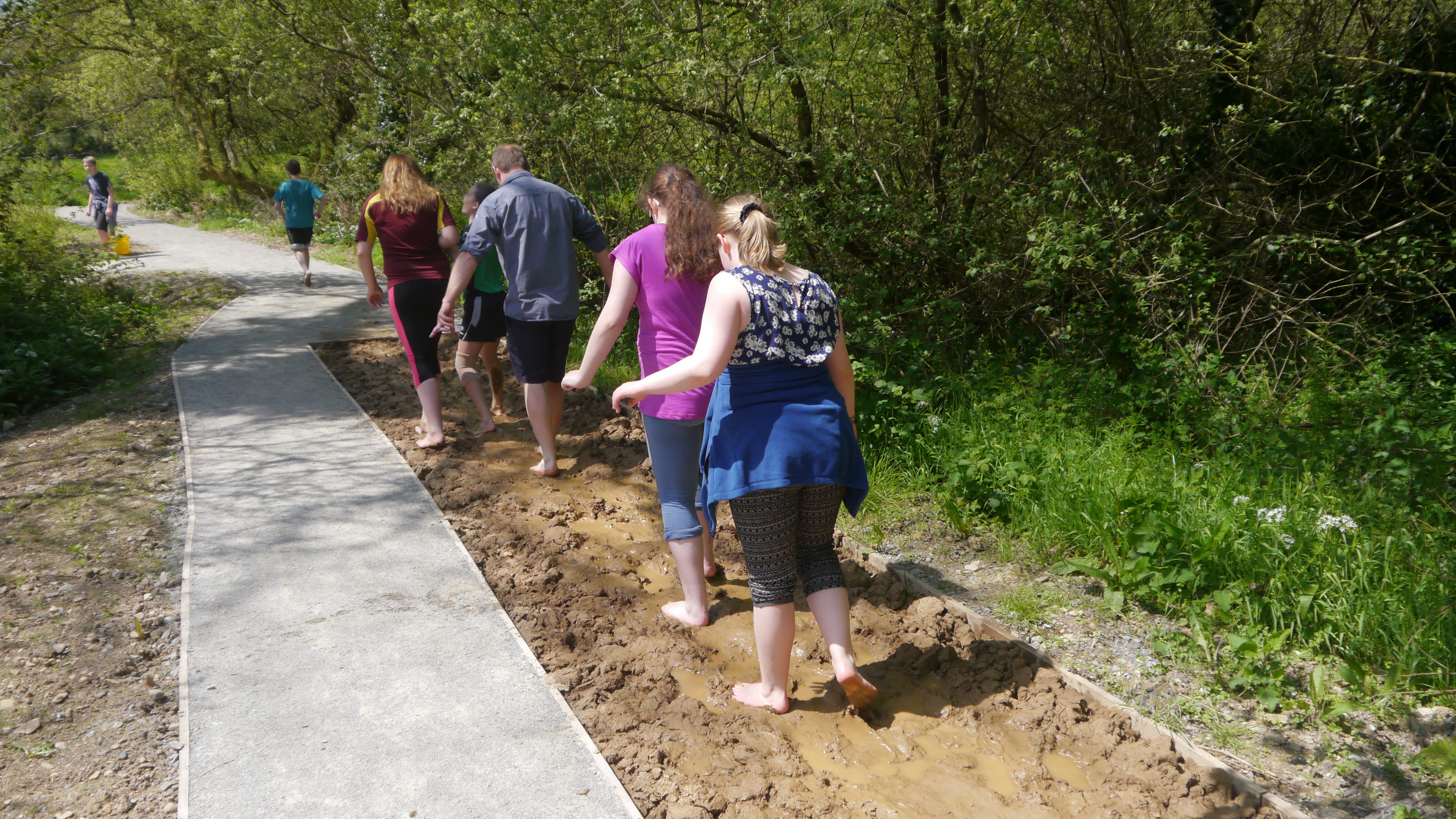 A group walk on the Barefoot Trail at Castell Henllys