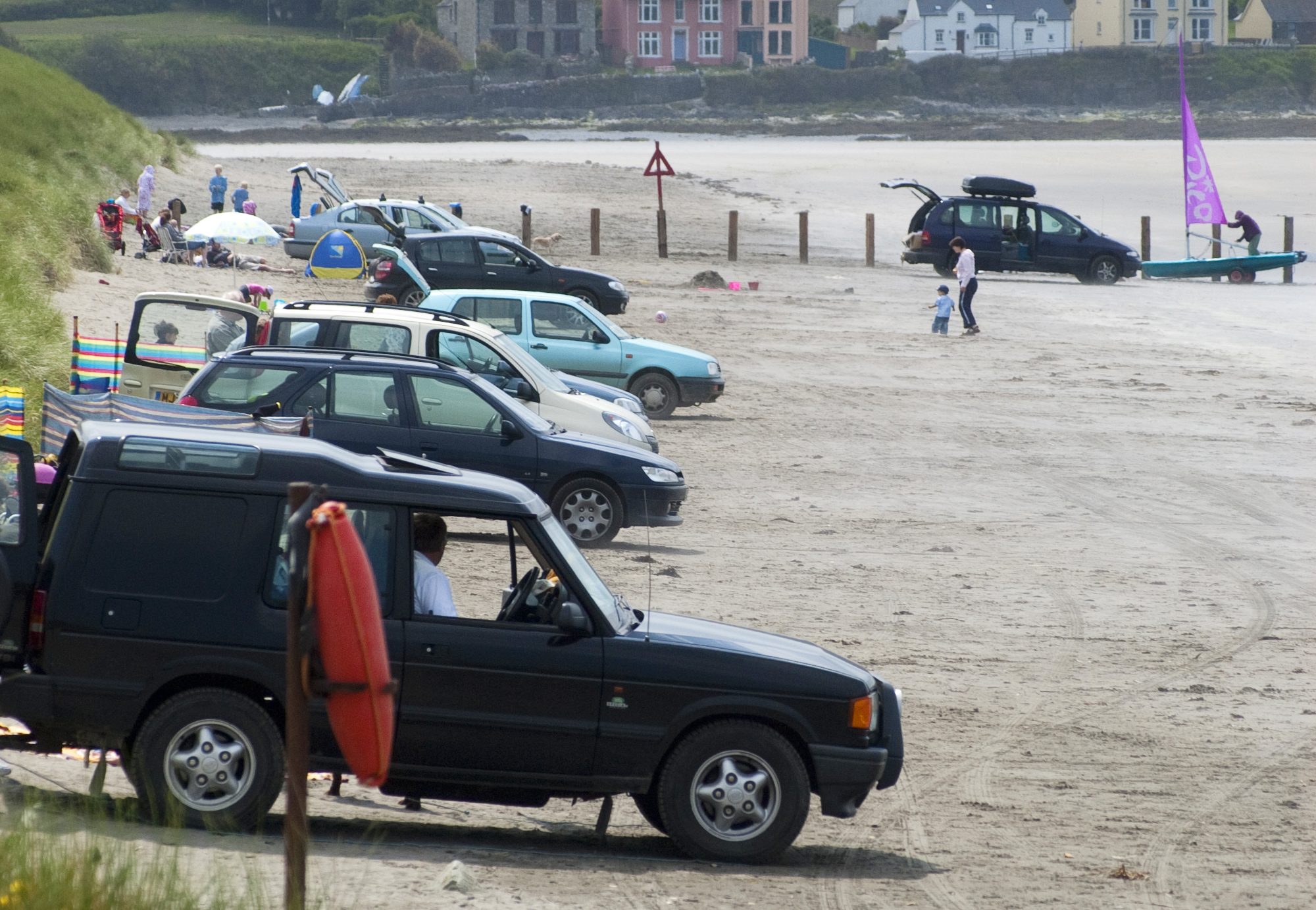 Cars parking on the beach at Newport Sands in the Pembrokeshire Coast National Park