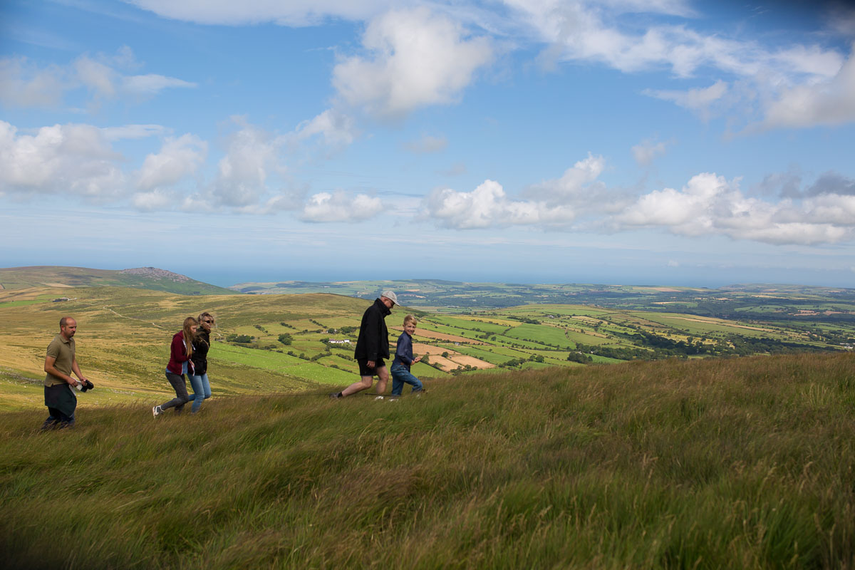 Family walking with a dog on a lead in the Preseli Hills, Pembrokeshire, Wales, UK