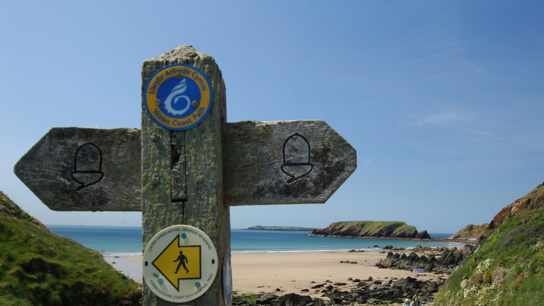 Wooden signpost on the Pembrokeshire Coast Path at Marloes Sands, Pembrokeshire, Wales, UK