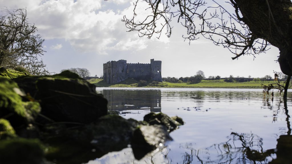 View across the Millpond to Carew Castle and Tidal Mill