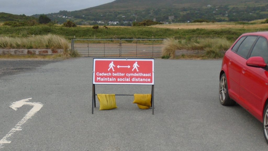 Social distancing sign in a car park