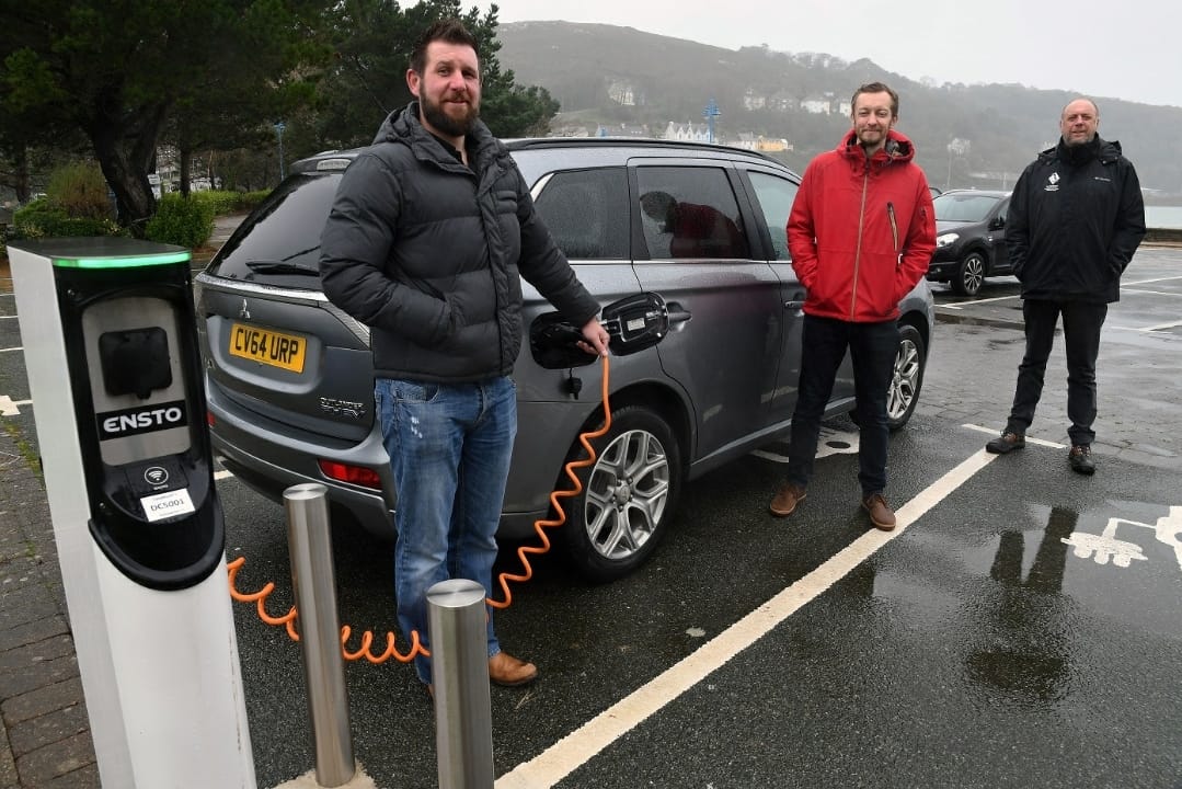 Pictured with the Council’s Sustainable Development and Energy Manager, Steve Keating (centre) at the electric vehicle charge-point at the Parrog in Goodwick are: Andrew Mackay (left), Construction Project Manager at Silverstone and Andrew Muskett, Building Projects Manager at the Pembrokeshire Coast National Park Authority.