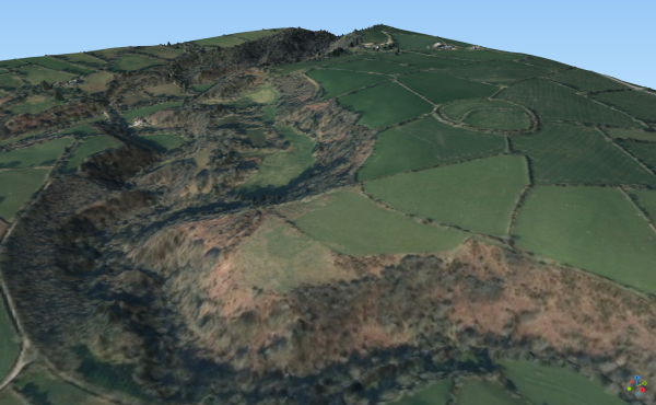 A 3D image of the Nevern Valley using lower resolution Lidar data (© Natural Resources Wales and Database Right. All rights reserved) overlaid with aerial photography (© Getmapping 2022). A circular prehistoric enclosure known as Castell Mawr can be seen above the valley.