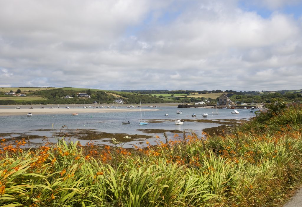 View of a coastla inlet with boats bobbing in the sea. Location pictured is Newport, Pembrokeshire