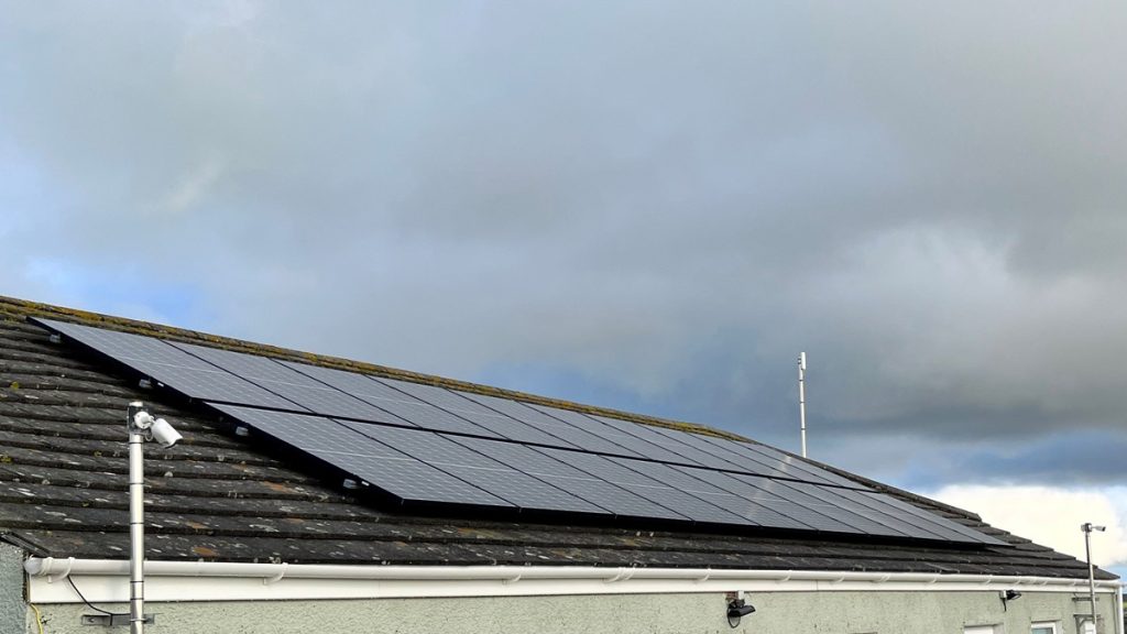 solar photovoltaic panels on the roof of a small building