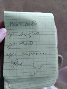 Poem written in Cymraeg (Welsh) in a notebook. It reads: Mae'r mor yn swyno yn rhuo yn mynnu sylw