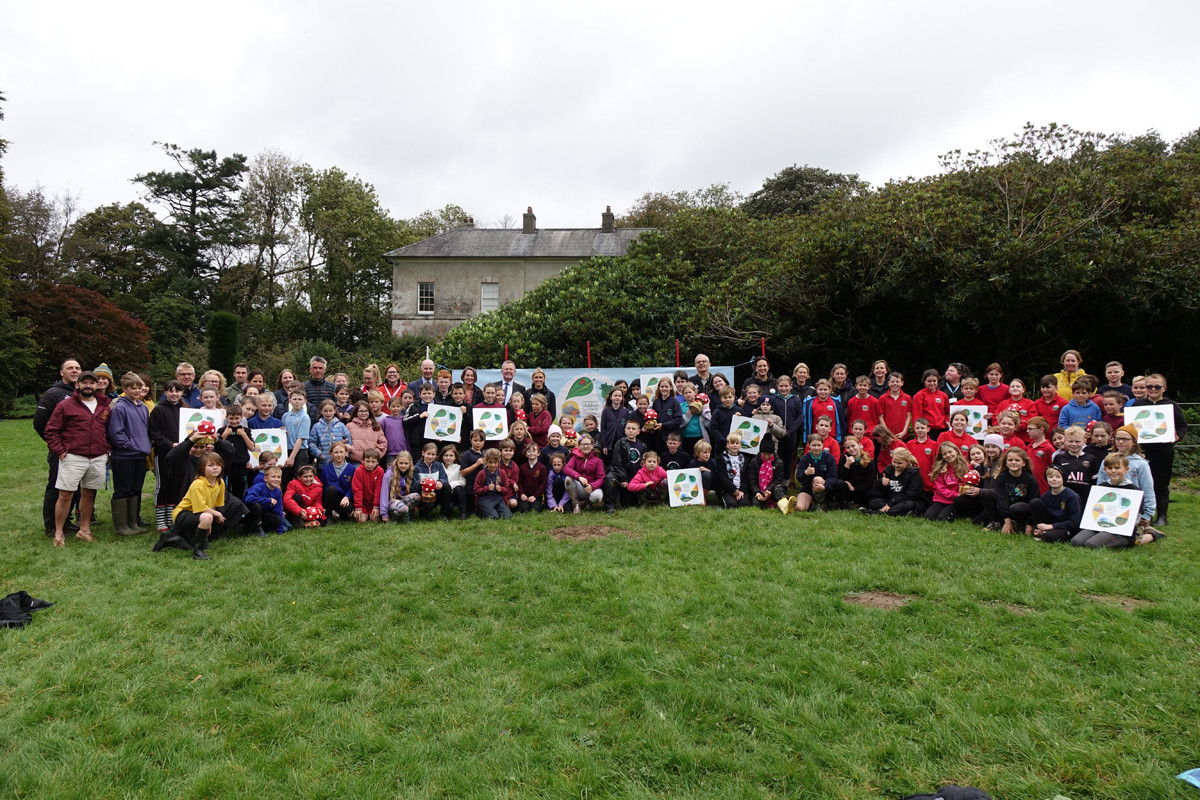 A group photograph showing representatives from ten Pembrokeshire schools and partners at the 2023 Pembrokeshire Outdoor Schools Celebration Day at Scolton Manor.