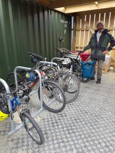 Gentleman standing next to solar bikes