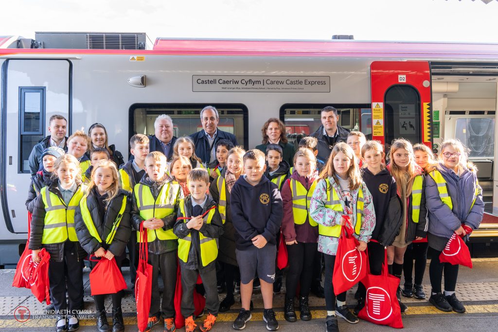 Schoolchildren standing in front of the Carew Castle Express