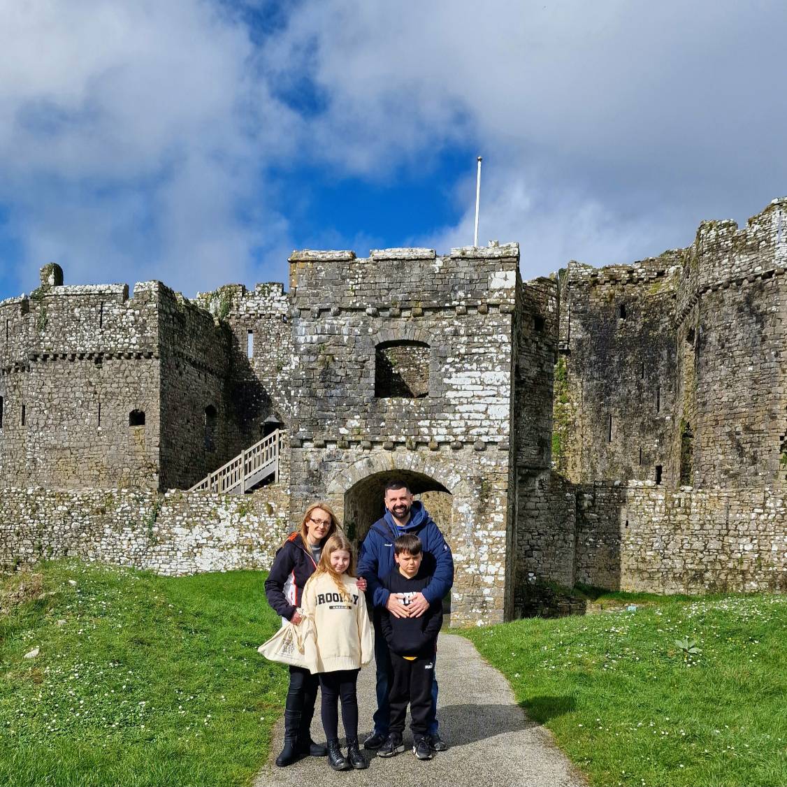 Rhys and his family standing outside Carew Castle