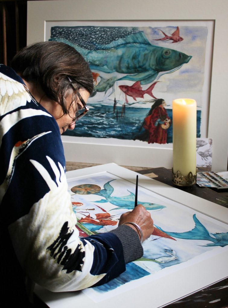 Artist Jackie Morris working on one of her paintings