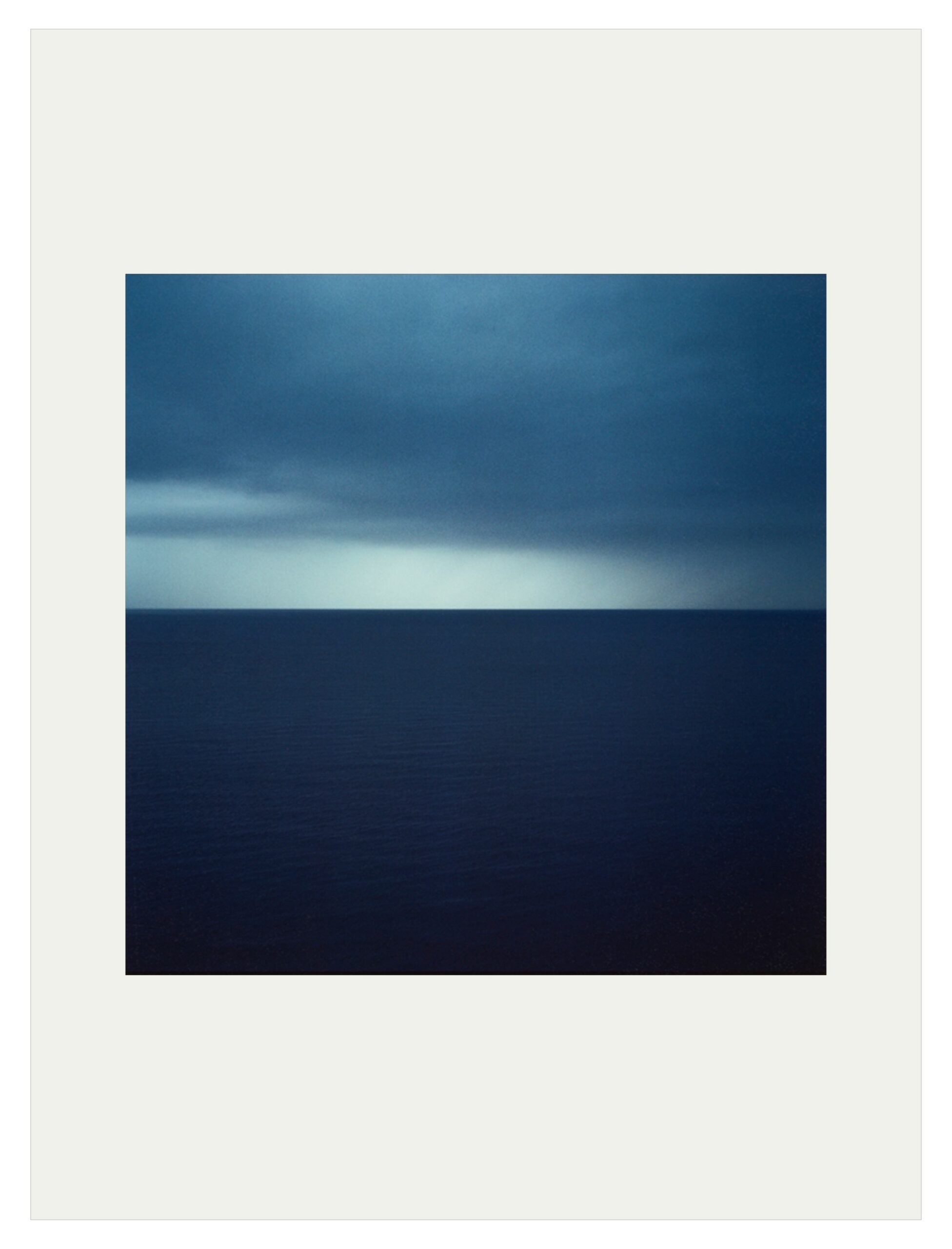 An artwork showing a dark sea horizon
