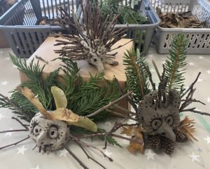 Three monsters made of clay, sticks and leaves.